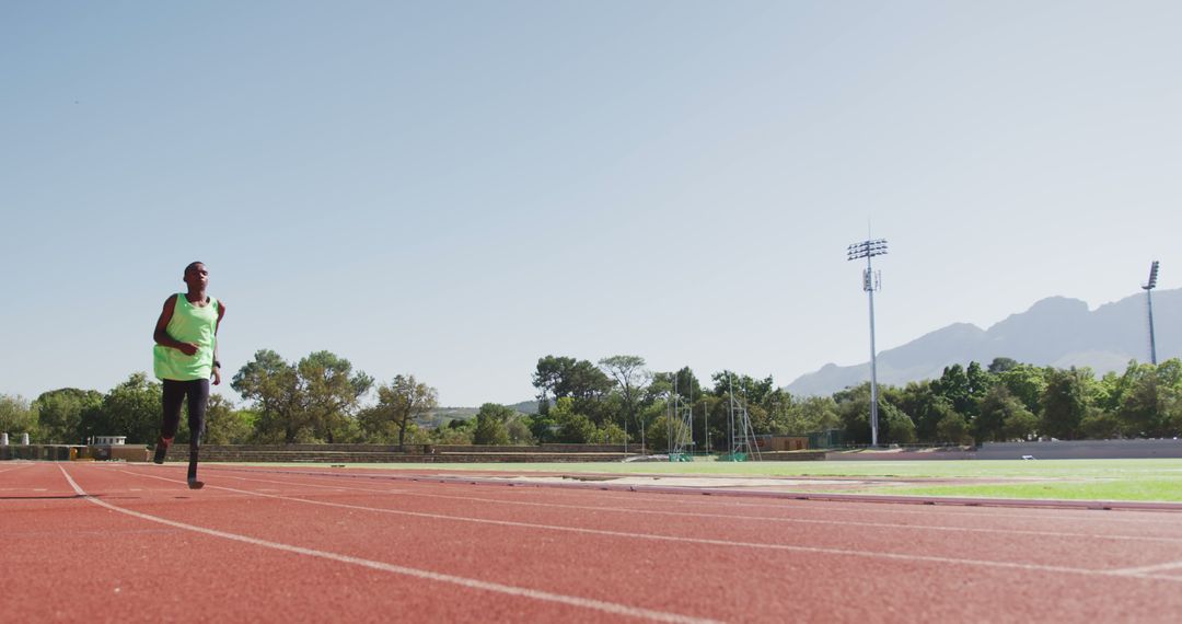 Athlete Running on Track with Prosthetic Leg Outdoors - Free Images, Stock Photos and Pictures on Pikwizard.com