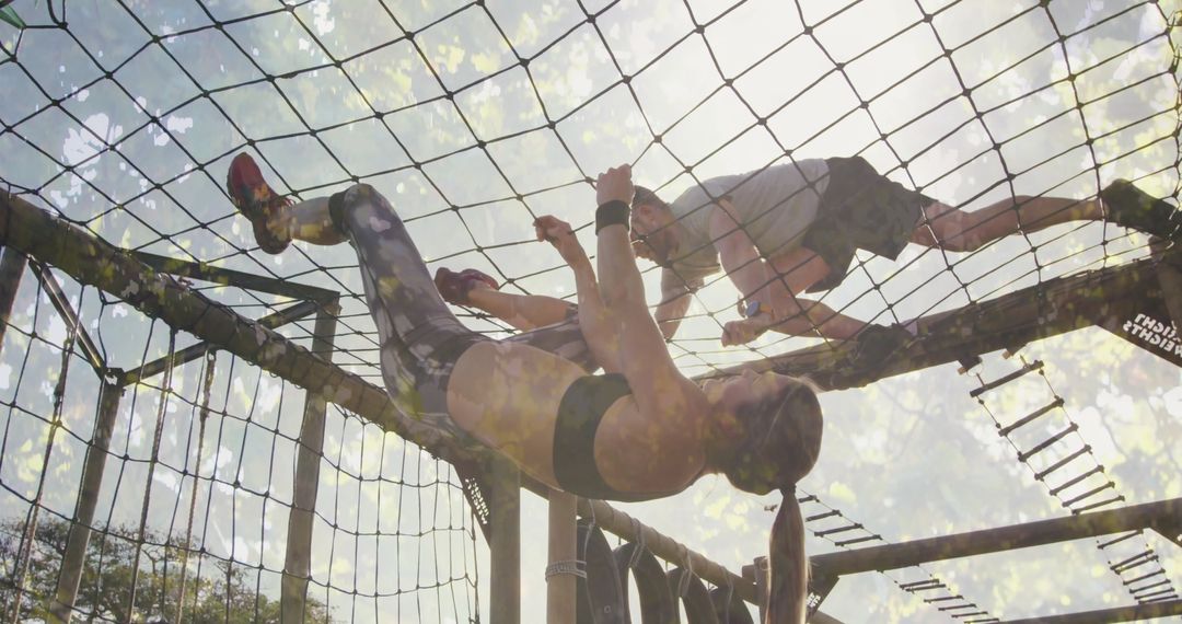 Athletic Friends Team Building on Obstacle Course Cargo Net