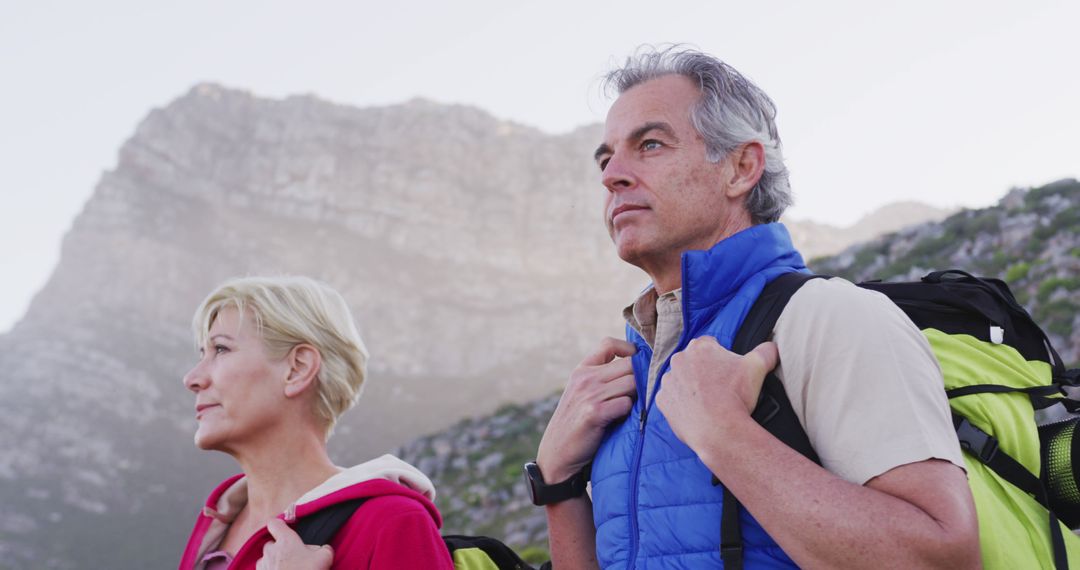 Senior Couple Hiking in Mountain Background During Daytime - Free Images, Stock Photos and Pictures on Pikwizard.com