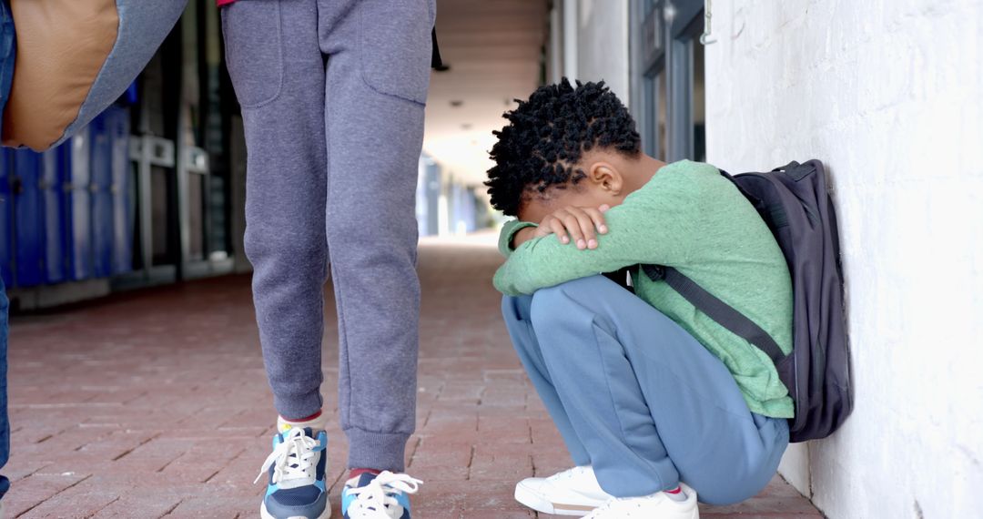 Child Experiencing Sadness in School Corridor