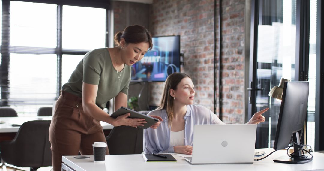 Collaborative Office Work with Colleagues Focused on Computer Screen