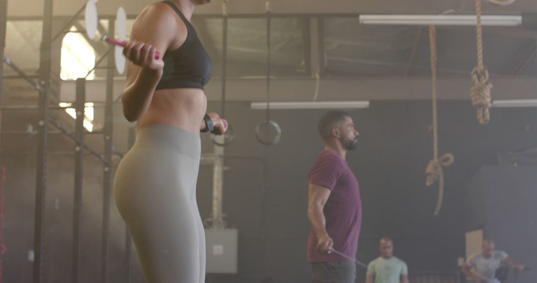 Athletic Individuals Exercising with Jump Ropes in Gym - Free Images, Stock Photos and Pictures on Pikwizard.com