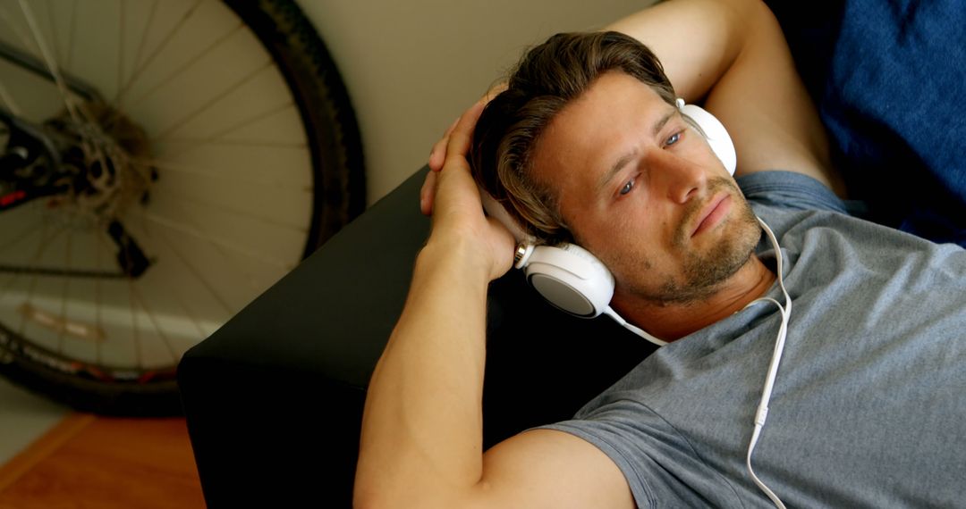 Relaxed Young Man Listening to Music with Headphones - Free Images, Stock Photos and Pictures on Pikwizard.com