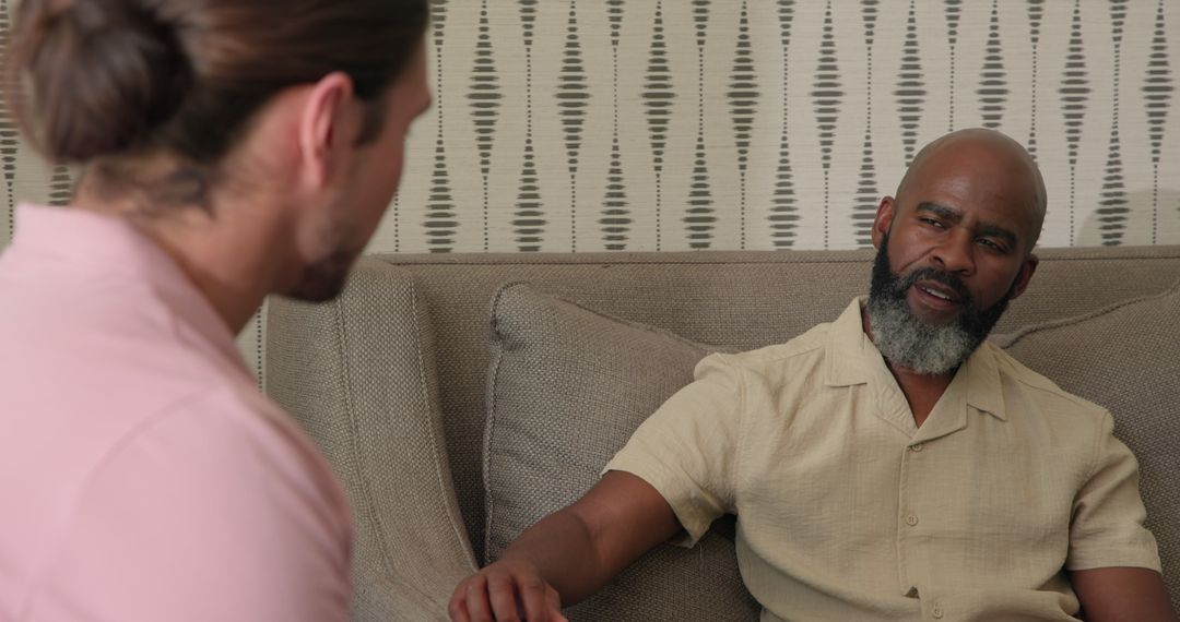 Two Men Discussing Few Issues at Home on Sofa