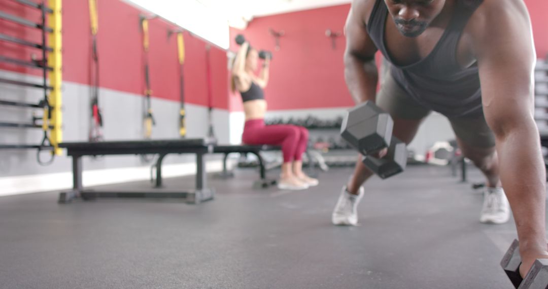 Man Performing Push-Up Rows in Gym During Workout Session