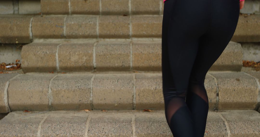 Person Climbing Outdoor Stairs in Black Athletic Leggings - Free Images, Stock Photos and Pictures on Pikwizard.com