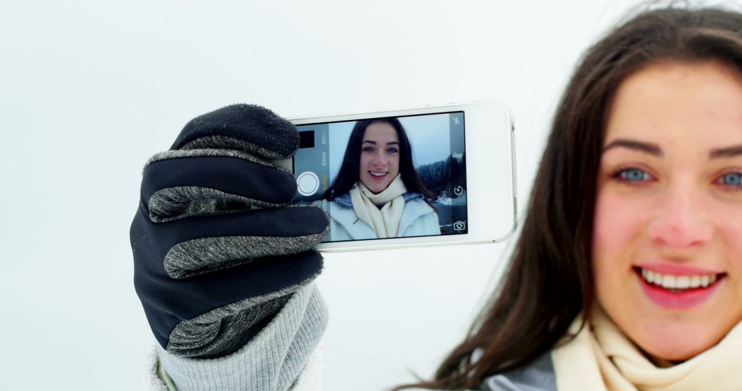 Young Woman Taking Winter Selfie with Smartphone - Free Images, Stock Photos and Pictures on Pikwizard.com