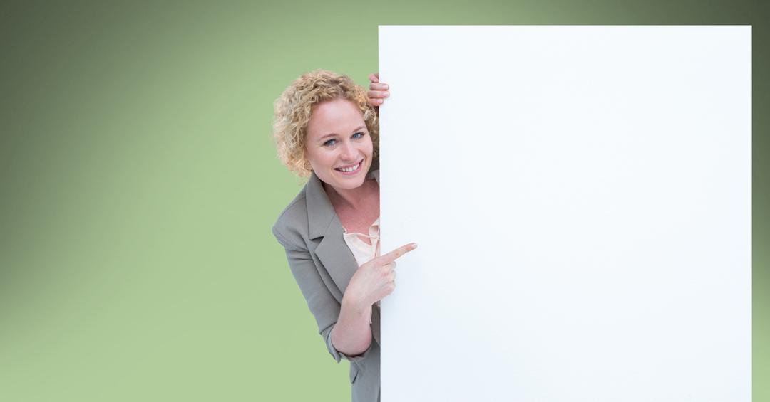 Businesswoman pointing at blank bill board - Free Images, Stock Photos and Pictures on Pikwizard.com