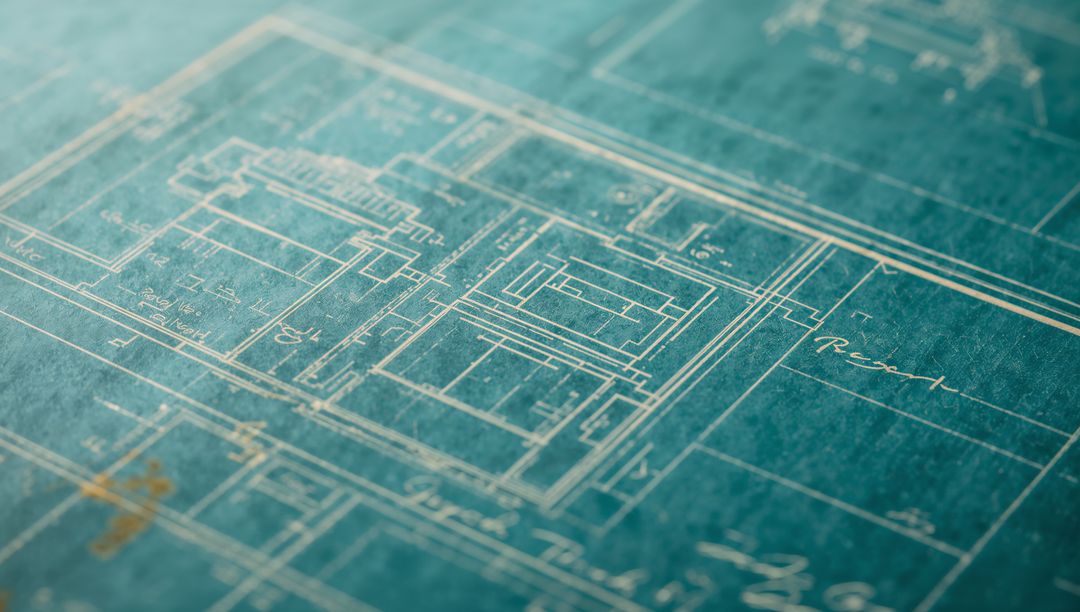 Teal blueprint showing architectural floor plan and grid markings on textured paper