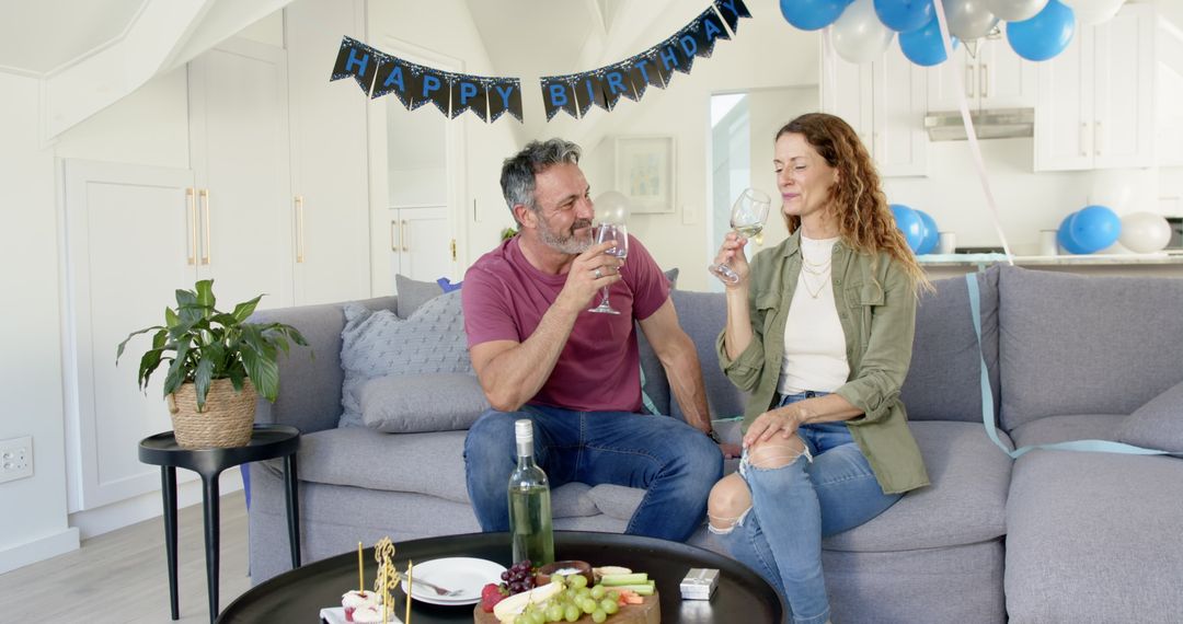 Mature Couple Celebrating Birthday at Home with Wine