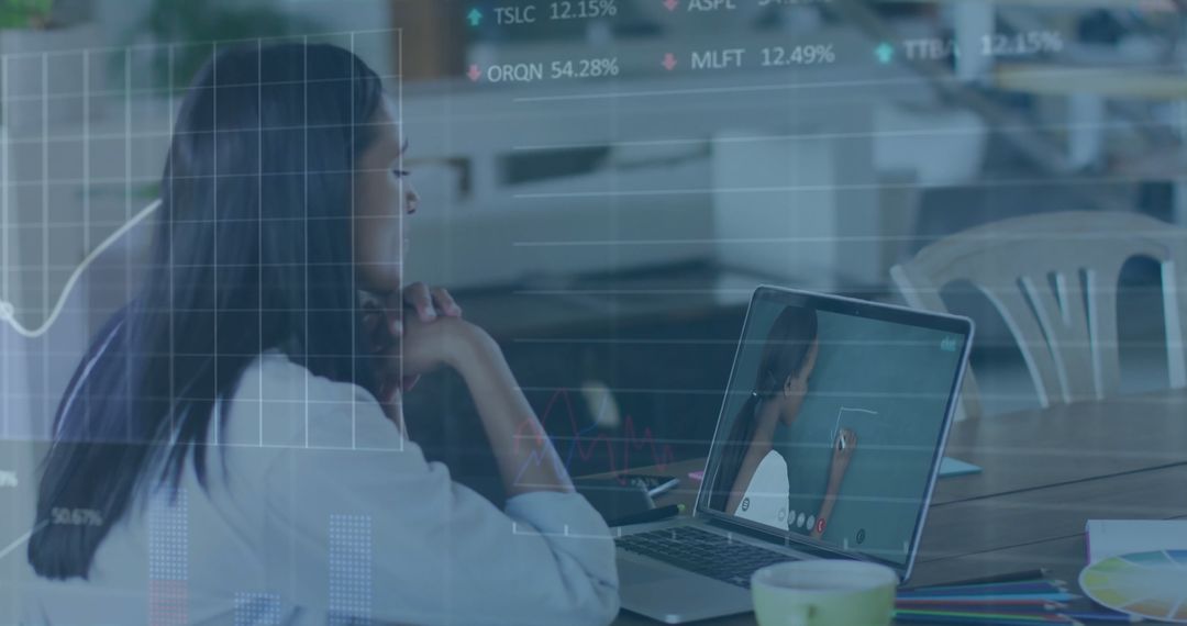Businesswoman Analyzing Data on Laptop in Modern Cafe Environment