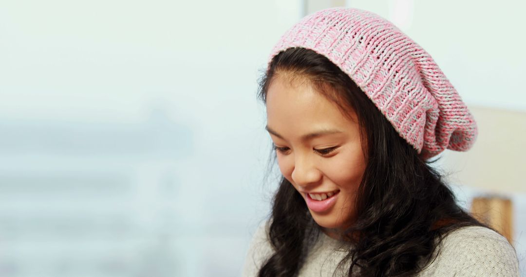 Smiling Young Woman Wearing Pink Knitted Beanie Hat - Free Images, Stock Photos and Pictures on Pikwizard.com