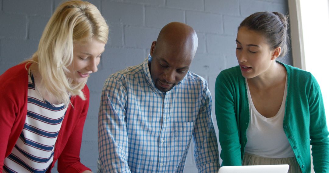 Diverse Team Collaborating on Project in Casual Office Environment