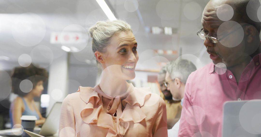 Diverse Coworkers Engaged in Lively Office Conversation