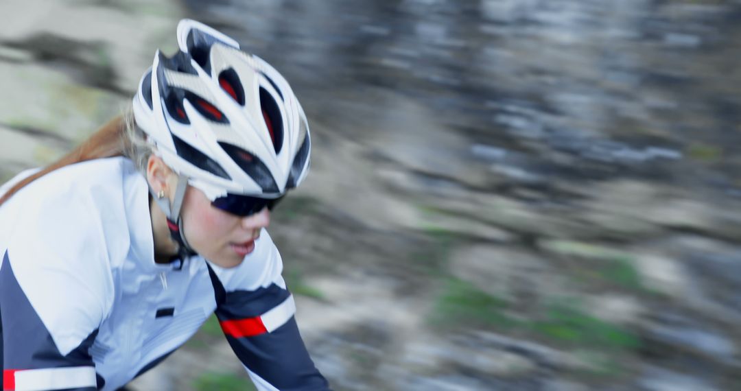 Female Cyclist in Motion with Helmet and Sunglasses - Free Images, Stock Photos and Pictures on Pikwizard.com