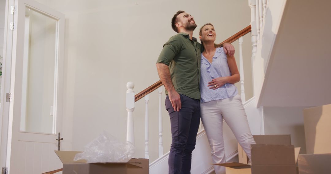 Joyful Couple Embracing New Beginnings in Unpacked Home