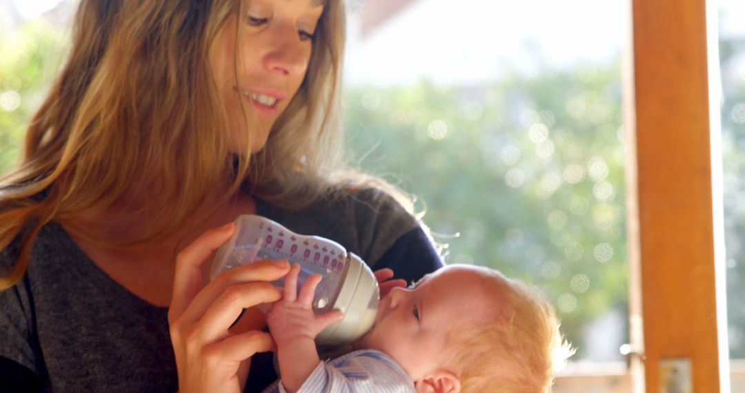 Mother Feeding Cute Newborn Baby with Milk Bottle at Home - Free Images, Stock Photos and Pictures on Pikwizard.com