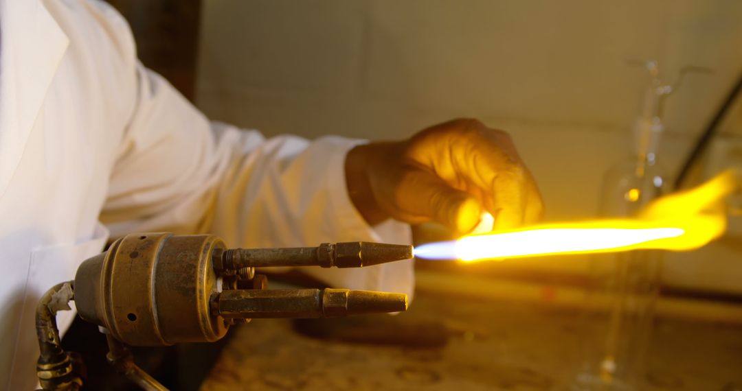 Scientist adjusting flame in laboratory with focused precision - Free Images, Stock Photos and Pictures on Pikwizard.com