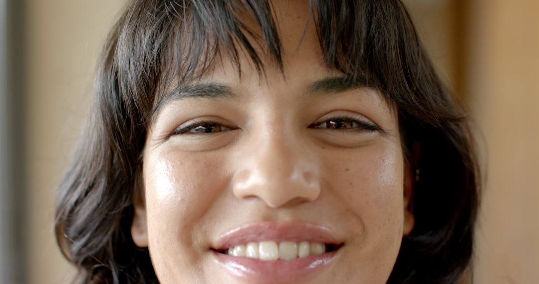 Smiling Woman with Freckles in Softly Lit Room