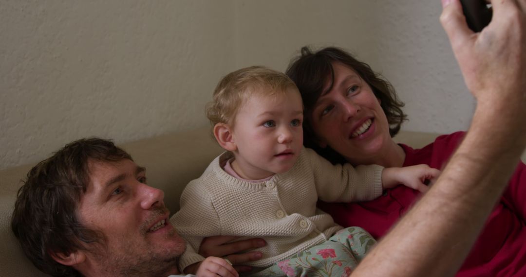 Young Family Taking Selfie Together on Couch at Home - Free Images, Stock Photos and Pictures on Pikwizard.com