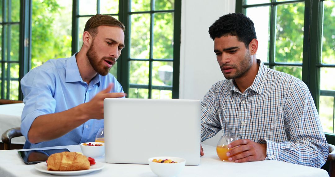 Diverse Business Colleagues in Intense Discussion at Cafe