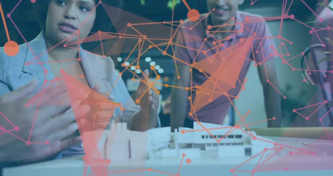 Design team collaborating over architectural model with augmented reality network overlay