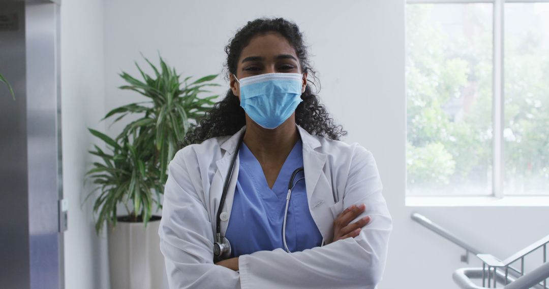 Confident Female Doctor Wearing Protective Face Mask in Hospital - Free Images, Stock Photos and Pictures on Pikwizard.com