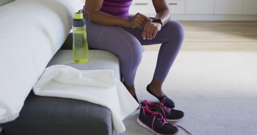 Woman Resting with Smartwatch after Workout at Home - Free Images, Stock Photos and Pictures on Pikwizard.com