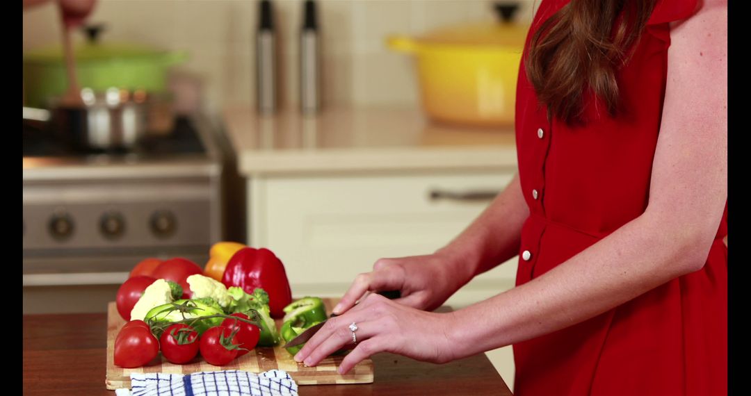 Woman in Red Dress Preparing Vegetables in Modern Kitchen - Free Images, Stock Photos and Pictures on Pikwizard.com