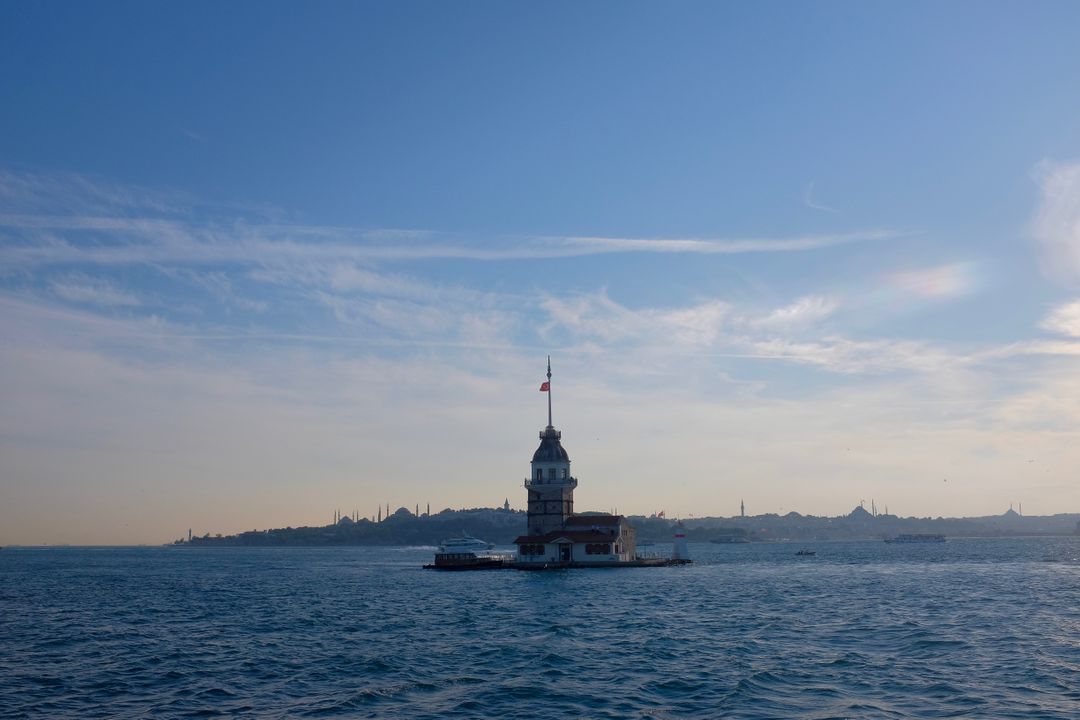 Maiden's Tower Amidst Serene Blue Waters under Clear Sky at Sunset - Free Images, Stock Photos and Pictures on Pikwizard.com