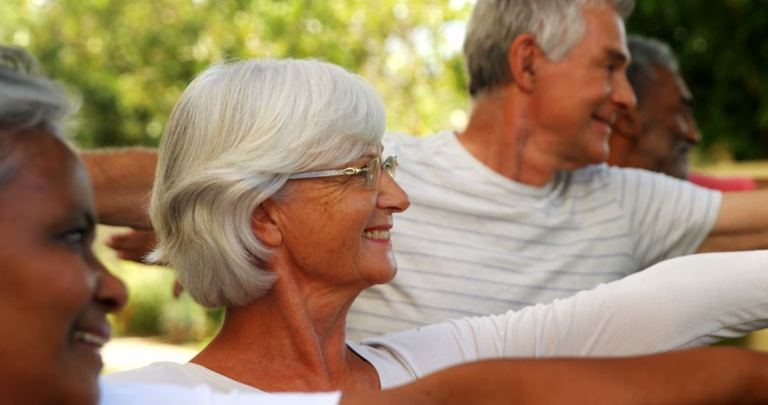 Seniors Enjoying Outdoor Arm Exercises in Park - Free Images, Stock Photos and Pictures on Pikwizard.com