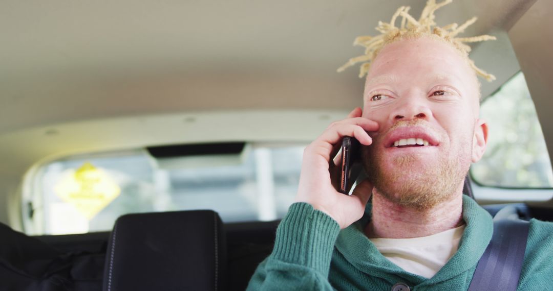 Man with Albinism Talking on Phone in Car Interior - Free Images, Stock Photos and Pictures on Pikwizard.com