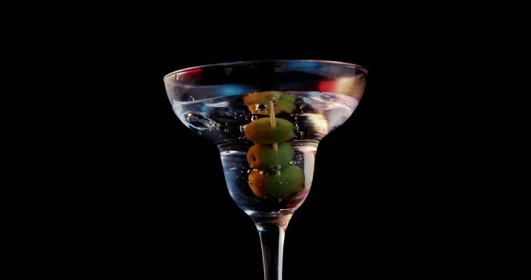 Elegant Martini Glass with Olives against Dark Background - Free Images, Stock Photos and Pictures on Pikwizard.com