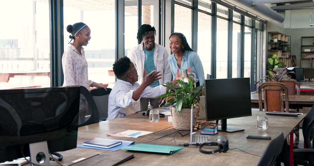 Dynamic Team Celebrating Success with Enthusiasm in Modern Workspace