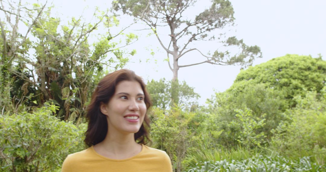 Woman Enjoying Serenity of Beautiful Botanical Garden