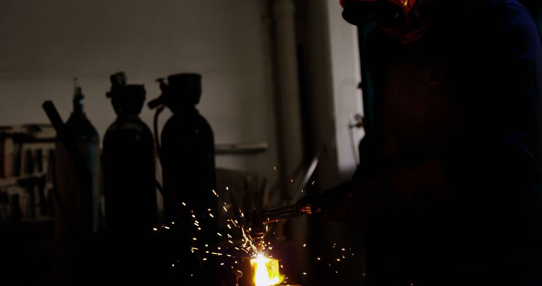 Factory Worker Using Welding Torch in Industrial Setting - Free Images, Stock Photos and Pictures on Pikwizard.com