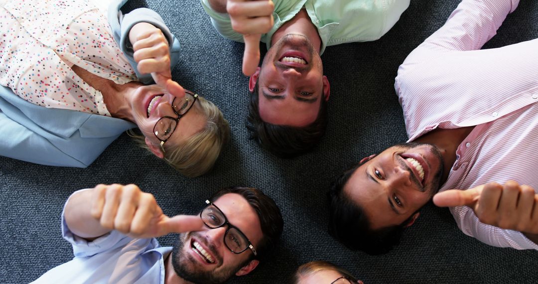 Diverse Office Team Giving Thumbs Up in Joyful Collaboration