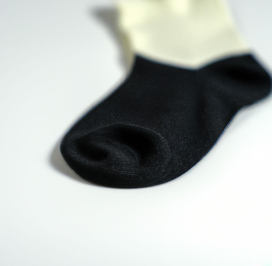 Close-Up of Black and White Sock on White Background - Free Images, Stock Photos and Pictures on Pikwizard.com