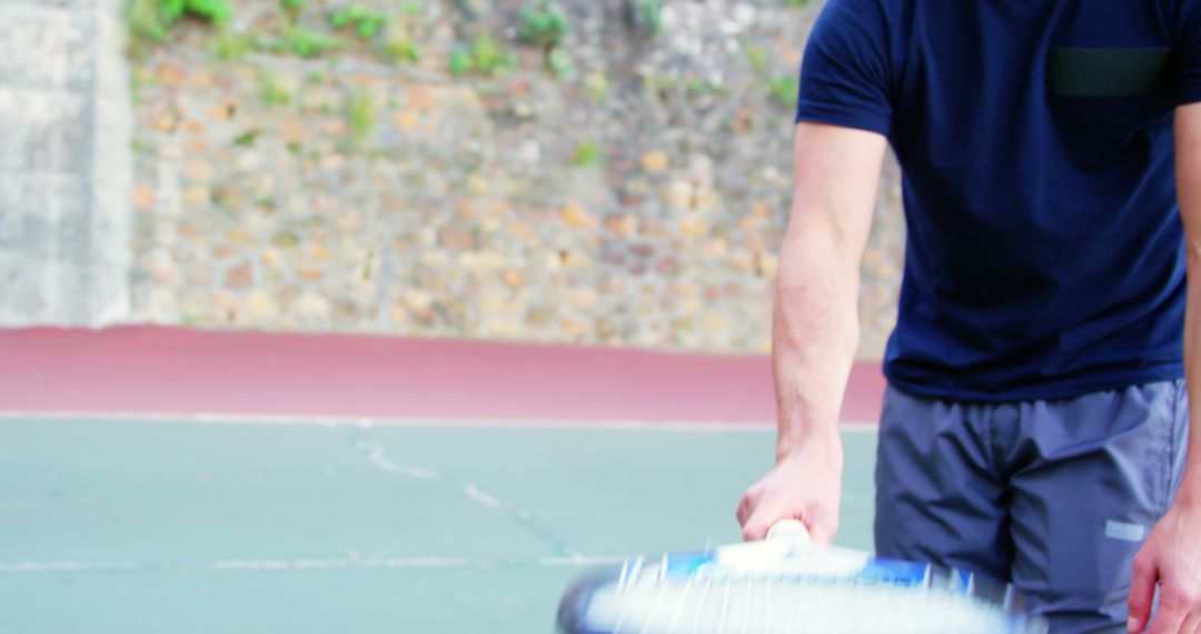 Man Playing Tennis Swinging Racket on Outdoor Court - Free Images, Stock Photos and Pictures on Pikwizard.com