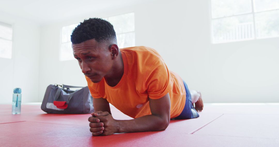 Focused Man Holding Plank Position in Gym - Free Images, Stock Photos and Pictures on Pikwizard.com