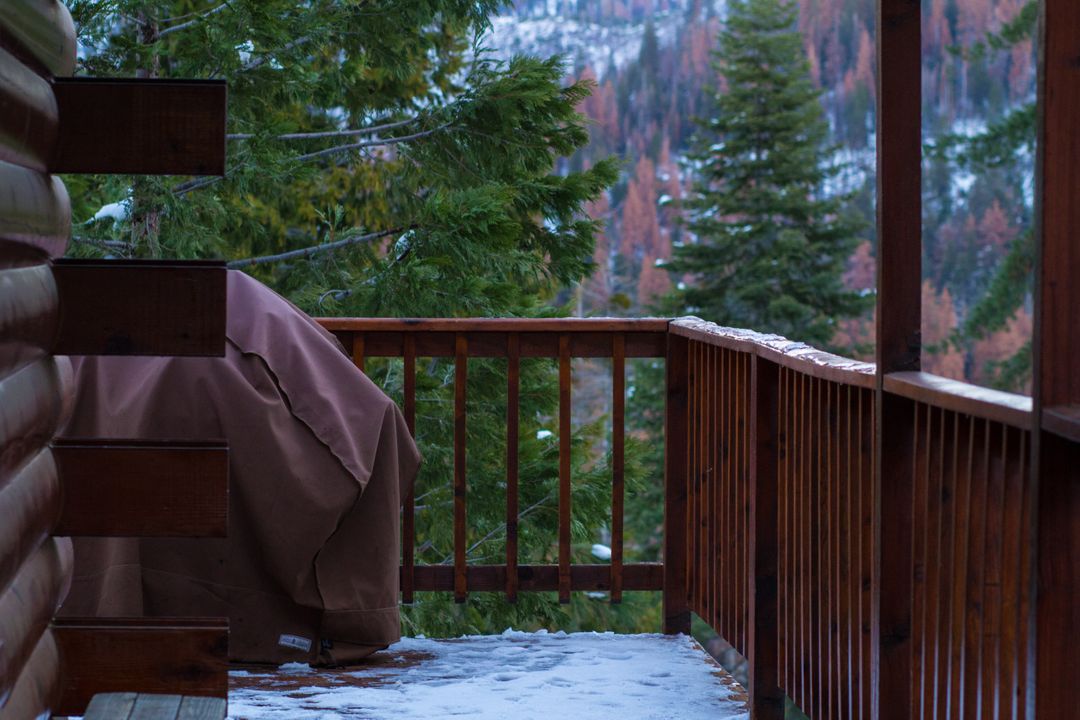 Snow-covered Balcony View At Rustic Cabin in Mountainous Forest - Free Images, Stock Photos and Pictures on Pikwizard.com