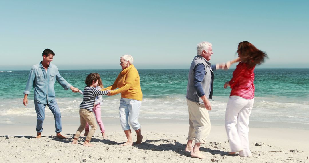 Multigenerational Family Enjoying Playtime on Sandy Beach - Free Images, Stock Photos and Pictures on Pikwizard.com