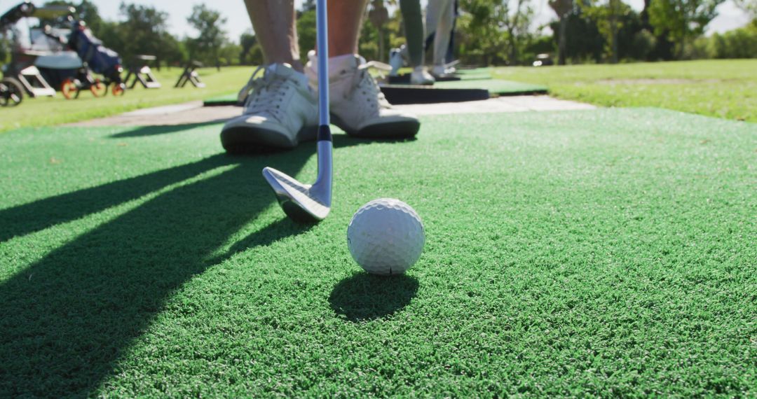 Golfer preparing to hit ball on driving range - Free Images, Stock Photos and Pictures on Pikwizard.com