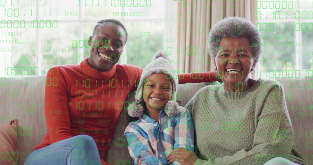 Three-generation Black family smiling on couch wearing sweaters with green binary overlay