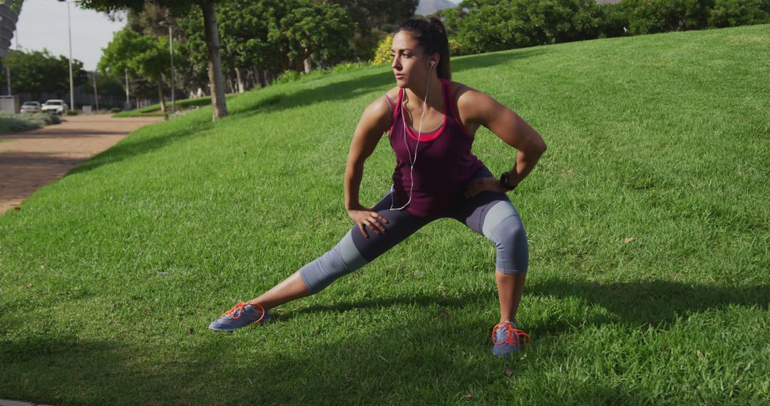 Female Athlete Stretching Legs in Outdoor Park on Sunny Day - Free Images, Stock Photos and Pictures on Pikwizard.com