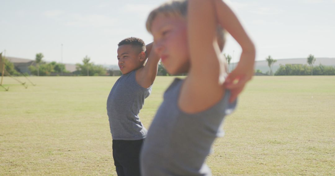 Young Boys Stretching Outdoors during Athletic Training - Free Images, Stock Photos and Pictures on Pikwizard.com