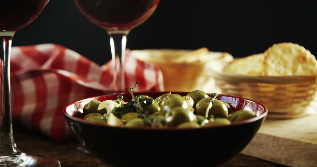 Appetizing Green Olives in Bowl with Red Wine and Crackers - Free Images, Stock Photos and Pictures on Pikwizard.com