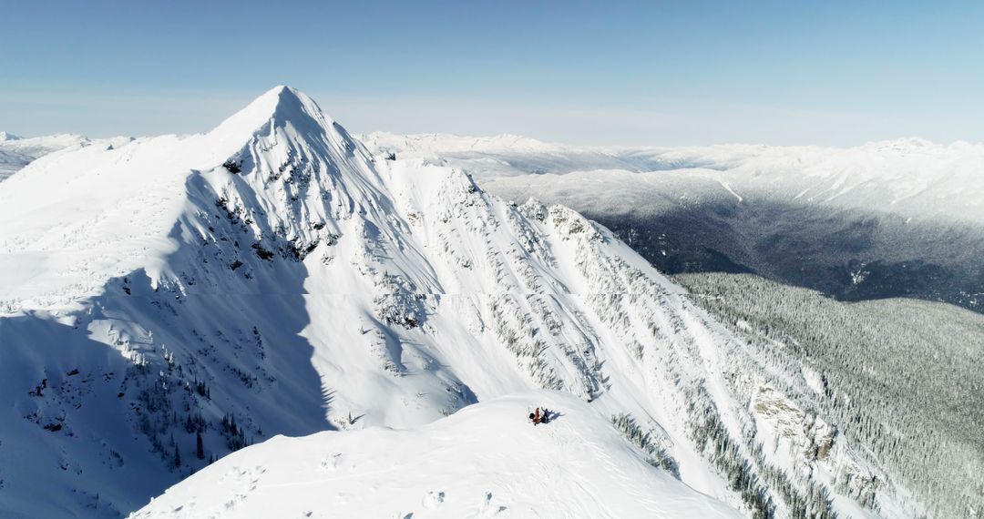 Aerial View of Climbers Resting on Snowy Mountain Peak - Free Images, Stock Photos and Pictures on Pikwizard.com