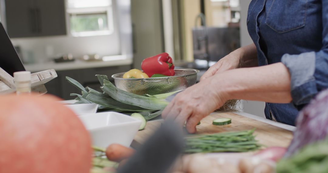 Midsection of Senior Caucasian Woman Chopping Vegetables in Kitchen - Free Images, Stock Photos and Pictures on Pikwizard.com