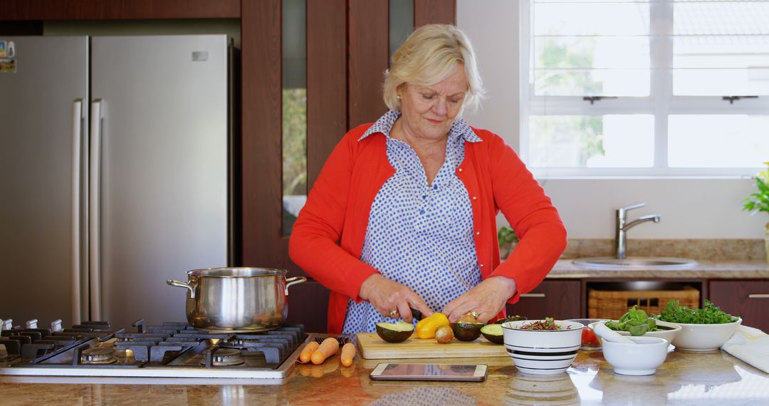 Senior Woman Preparing Healthy Salad in Modern Kitchen - Free Images, Stock Photos and Pictures on Pikwizard.com